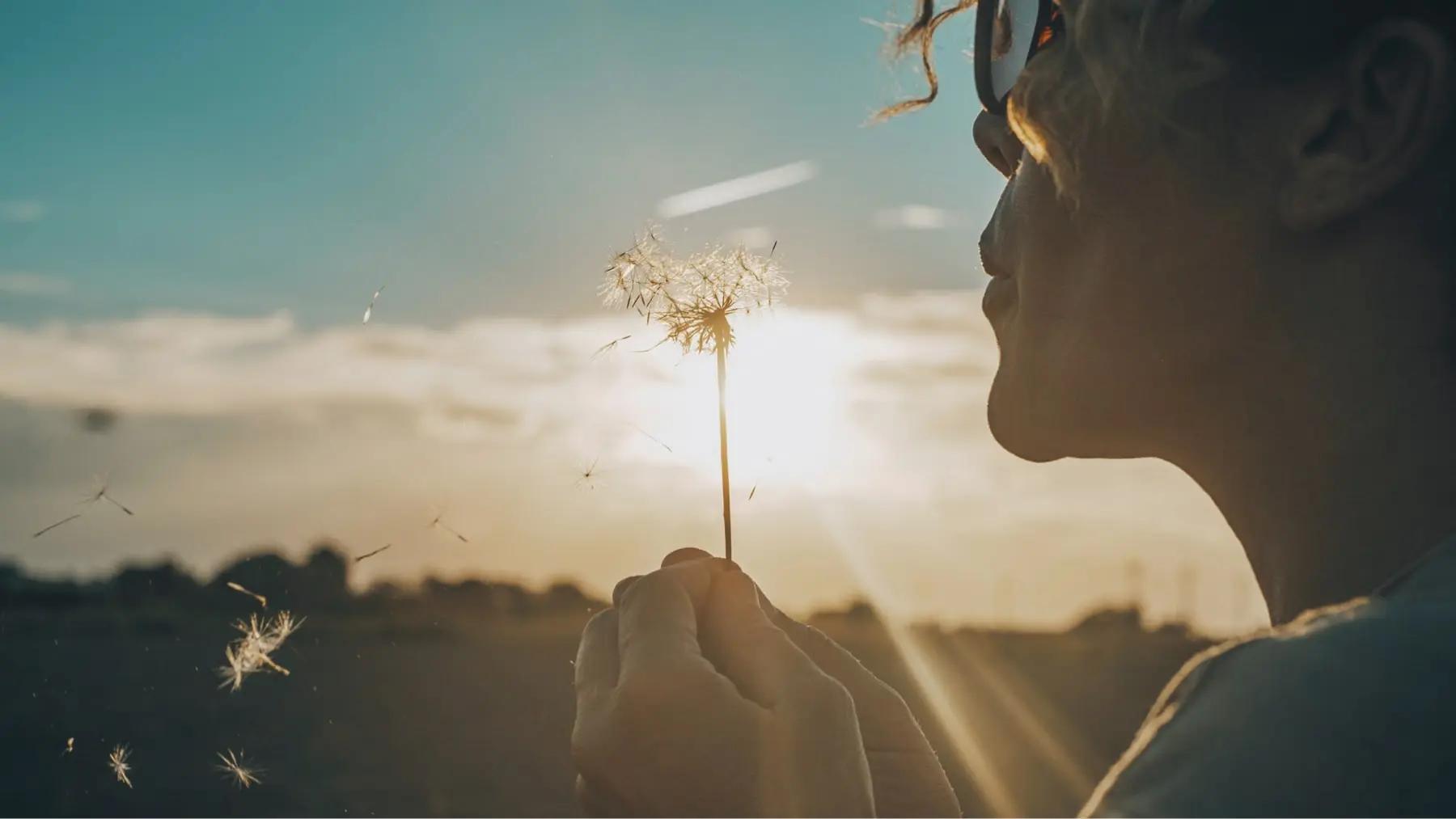 A woman sitting peacefully by a calm lake
