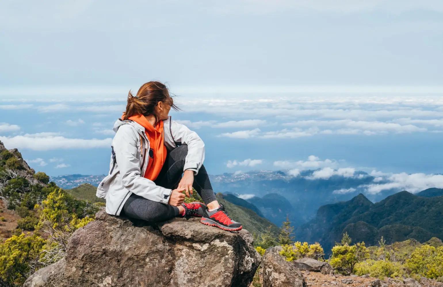 A woman removing a blindfold, stepping into clarity and light