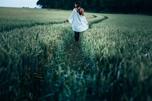 woman walking through field