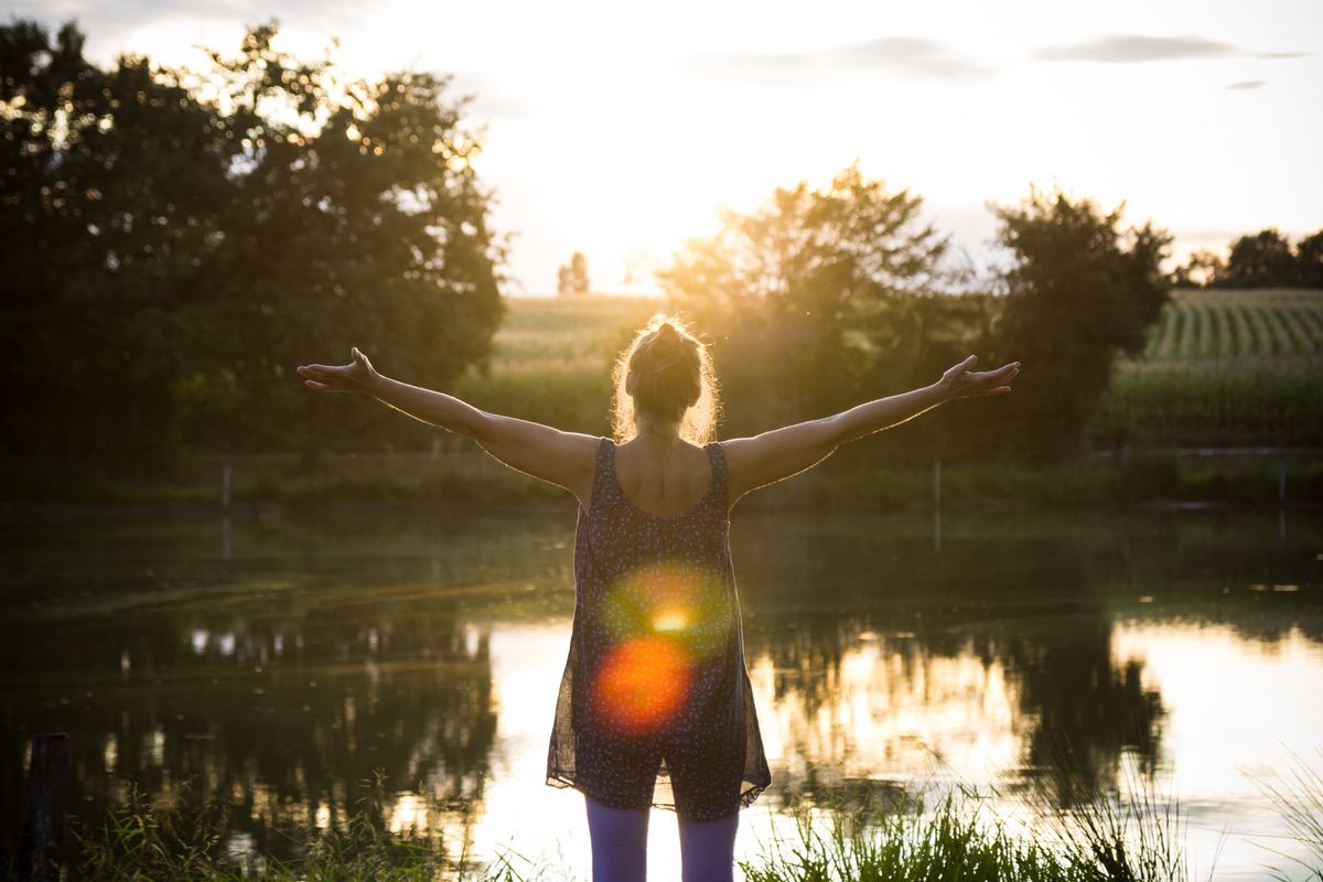 woman embracing the sunrise